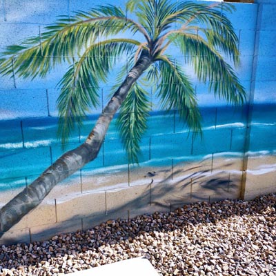 Backyard wall mural of a tropical white sand beach with palm trees and a clear blue sky.