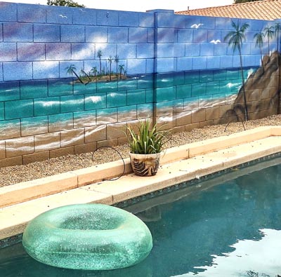 Serene beach sunset mural creating a chill atmosphere for a backyard patio.