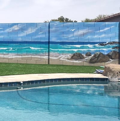 Relaxing tropical beach mural painted on an Arizona backyard privacy wall.