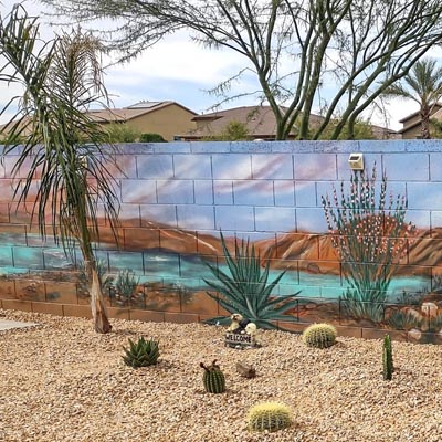 Stunning desert lake sunset mural adding depth to a backyard patio wall.