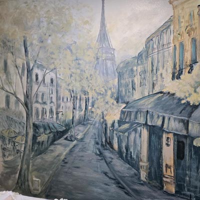 Charming indoor wall mural depicting a classic French street scene with cafes.