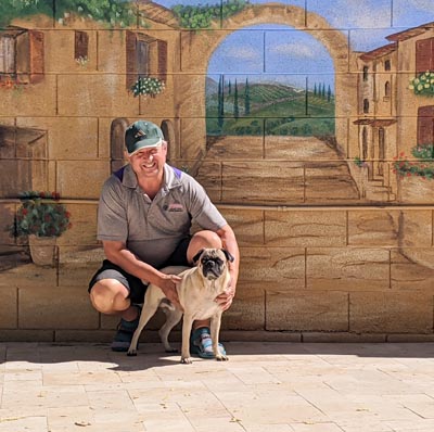 Detailed wall mural of a charming Italian countryside cobblestone street.