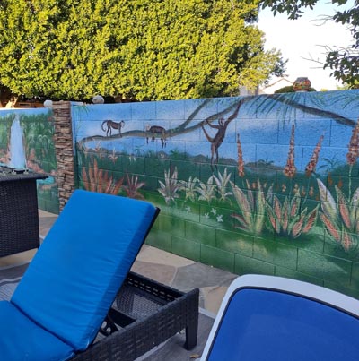 Lush jungle poolside mural featuring tropical greenery and aquarium-inspired details.